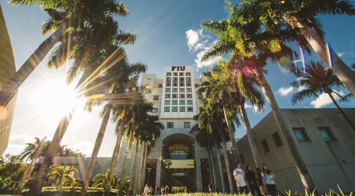 Florida International University campus with palms trees and students walking to class